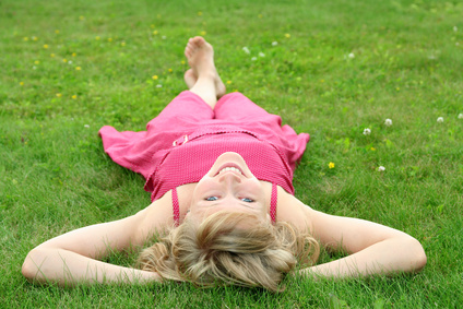 Woman lying on grass, smiling